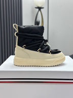 Moncler single high-top sneaker on display, black upper with cream sole and laces