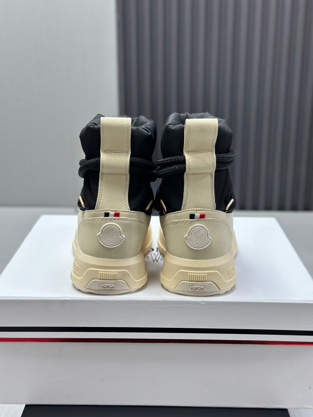 Moncler sneakers from back view, black and cream high-top lace design
