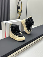Moncler high-top sneakers pair, black uppers with cream soles and lace ties