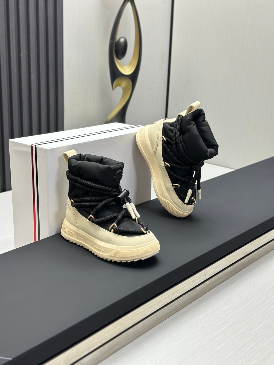 Moncler high-top sneakers pair, black uppers with cream soles and lace ties