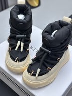 Moncler high-top sneakers with black padded collars, cream soles, and lace-up ties