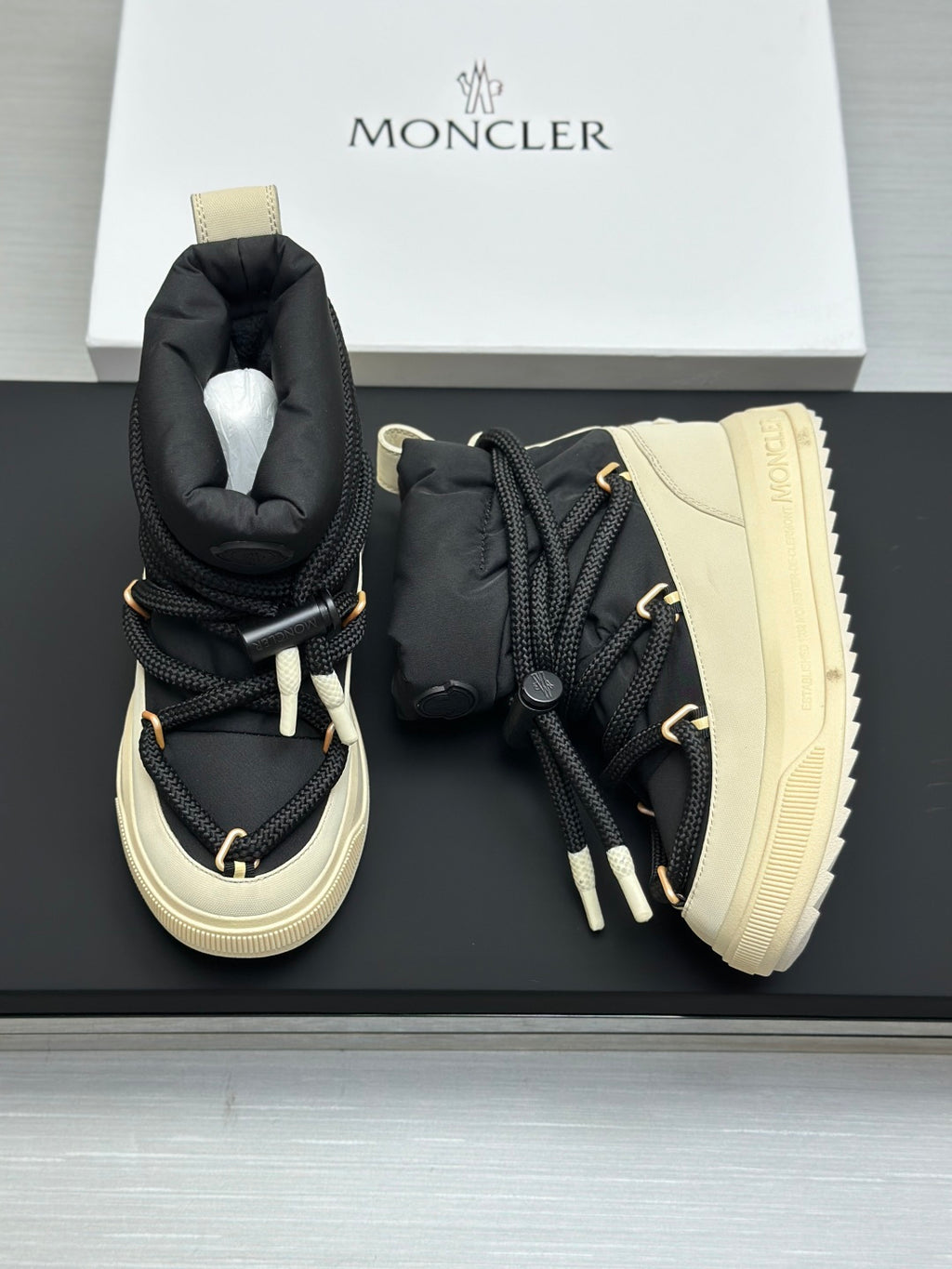 Moncler pair of high-top sneakers with black uppers and cream treaded soles