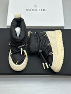 Moncler pair of high-top sneakers with black uppers and cream treaded soles