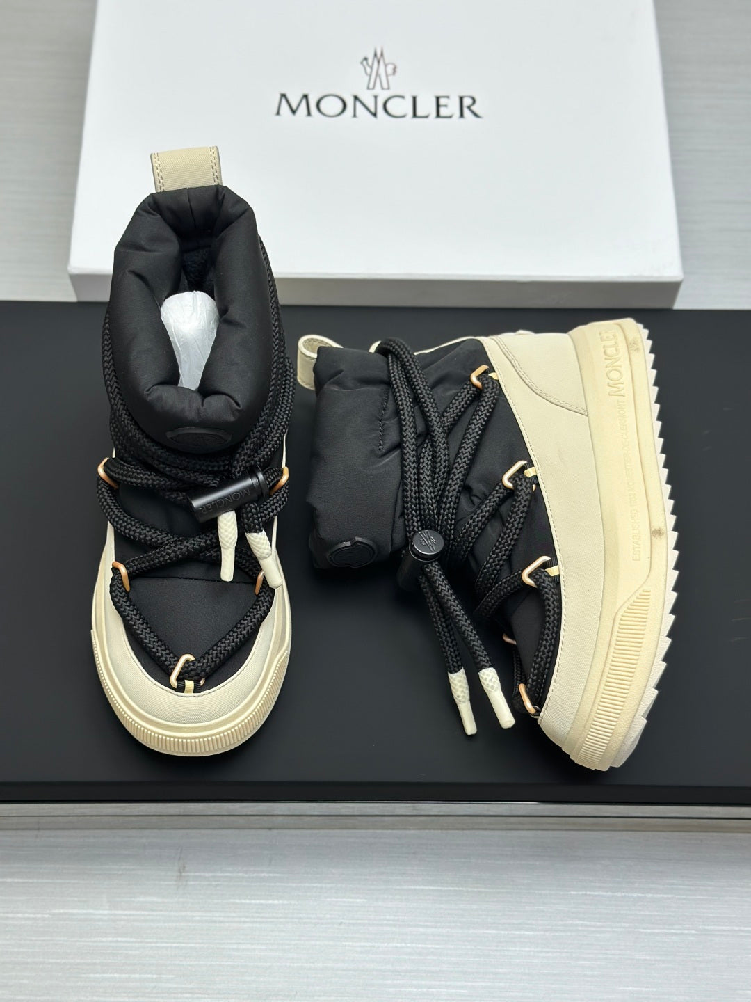 Moncler pair of high-top sneakers with black uppers and cream treaded soles