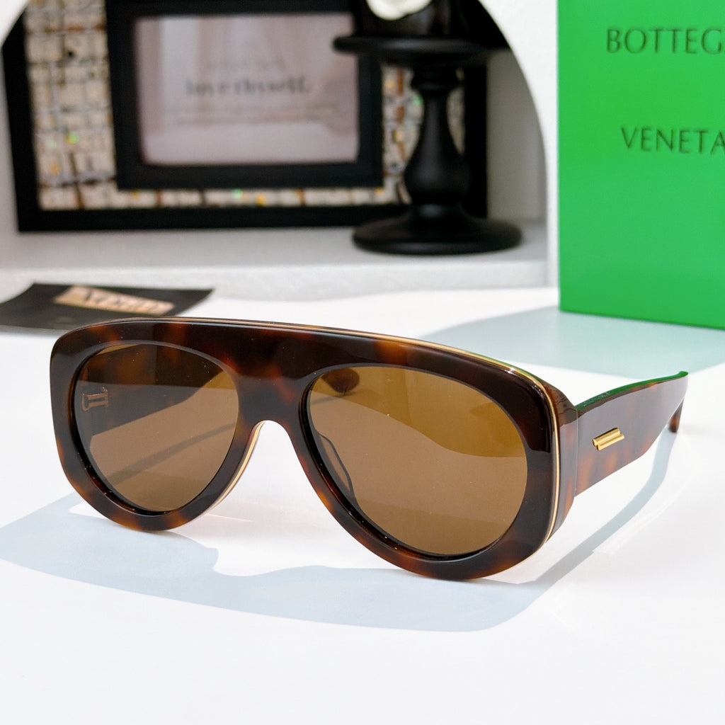 Tortoise brown sunglasses with amber lenses and green-accent temples.