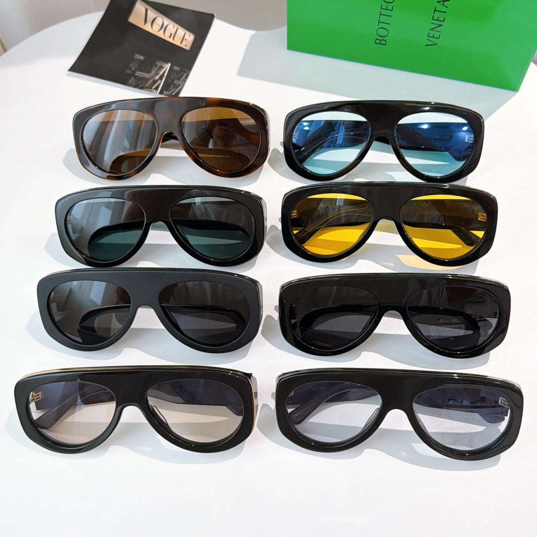 Assorted oversized sunglasses display with mixed colored lenses on black frames.