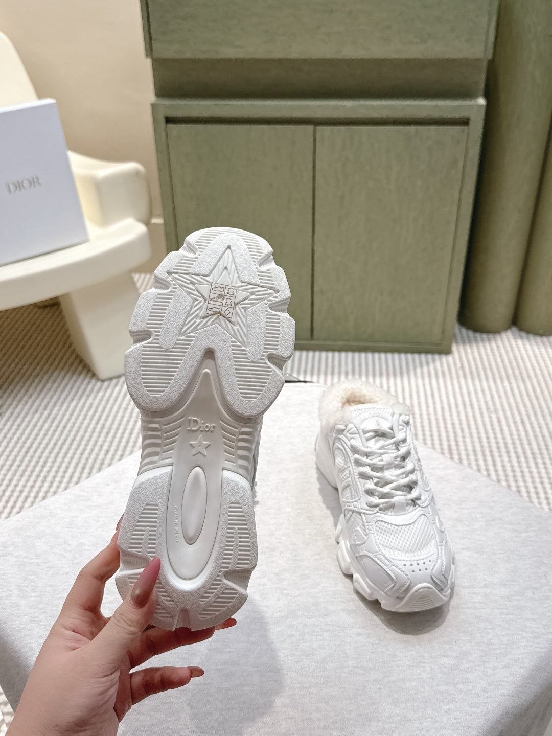 White sneakers with patterned tread outsole visible on the back and lace-up top