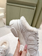 White sneaker with fur collar and thick tread sole, shown from the heel side