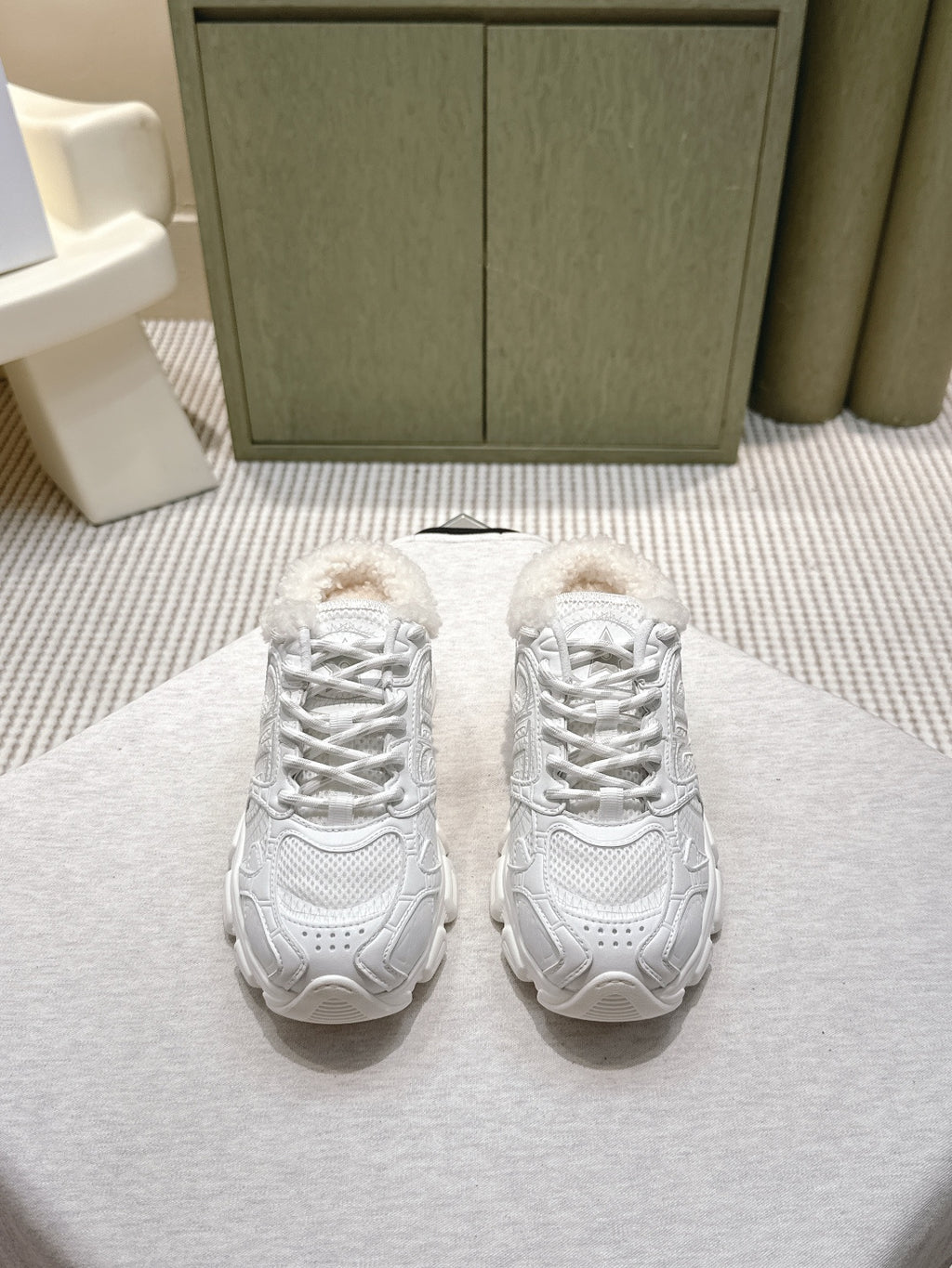 White unisex sneakers with lace-up front and fuzzy shearling collar detail