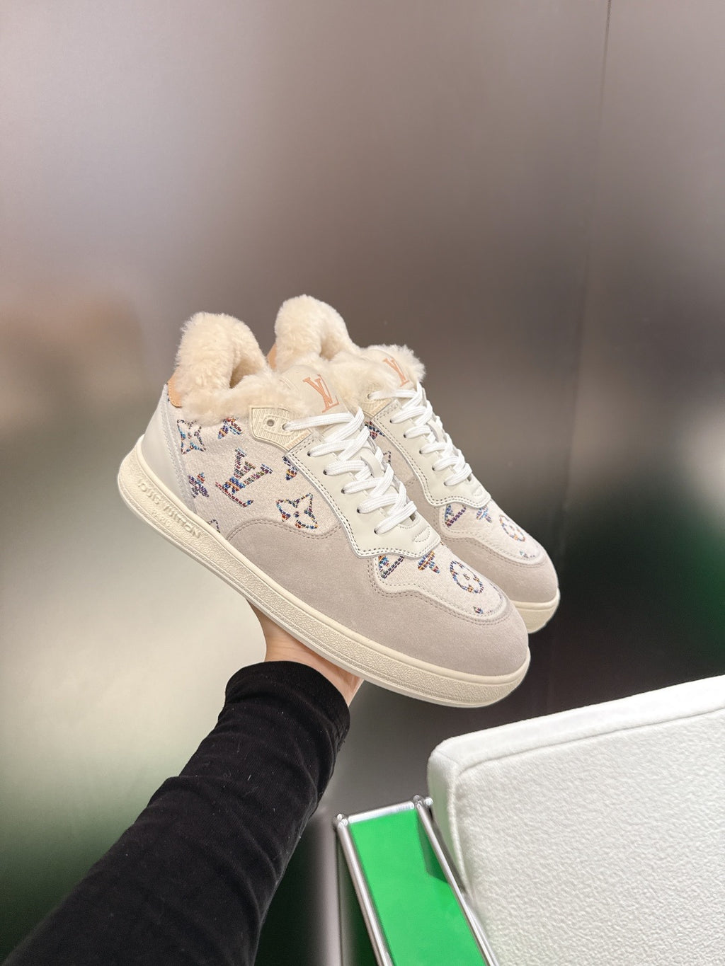 White Louis Vuitton high-top sneakers with monogram pattern and fuzzy shearling collar