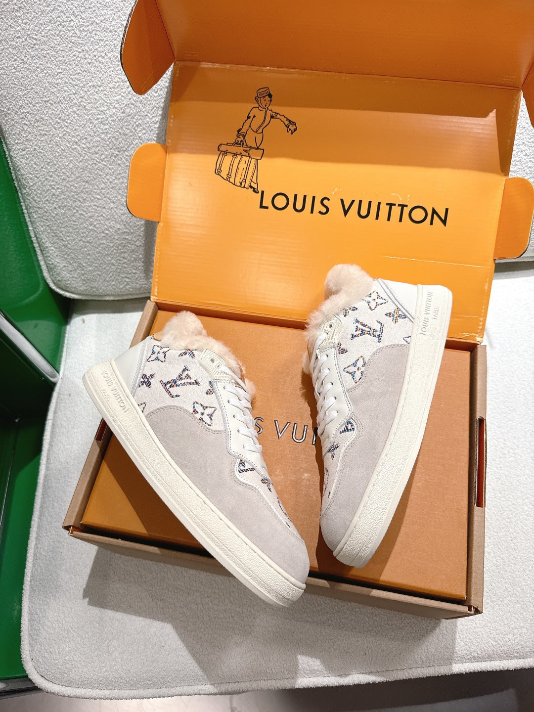 White Louis Vuitton high-top sneakers with monogram pattern and shearling lining