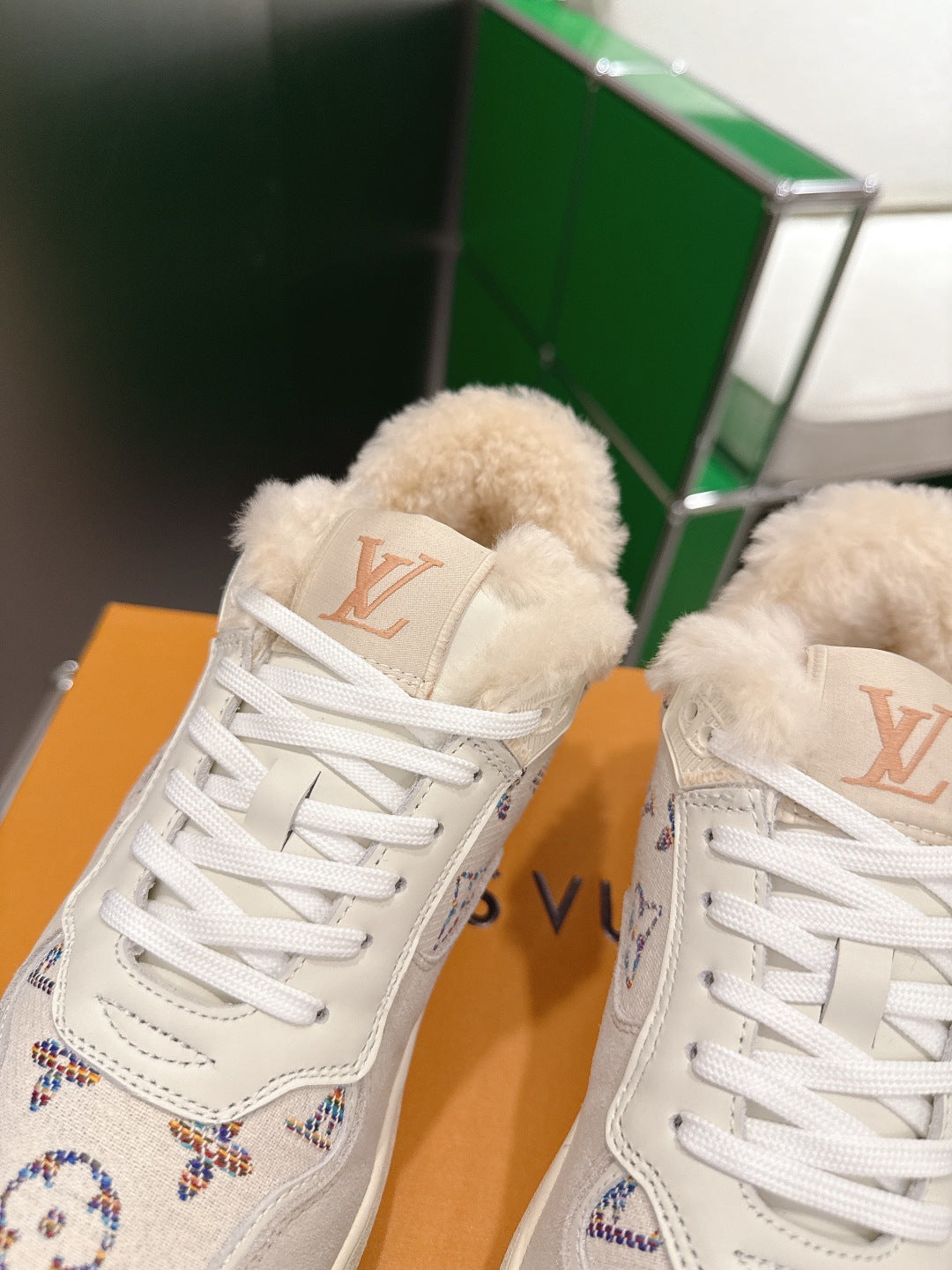 White Louis Vuitton high-top sneakers with shearling tongue and lace-up front
