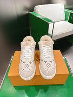 White Louis Vuitton high-top sneakers with shearling collar and monogram details