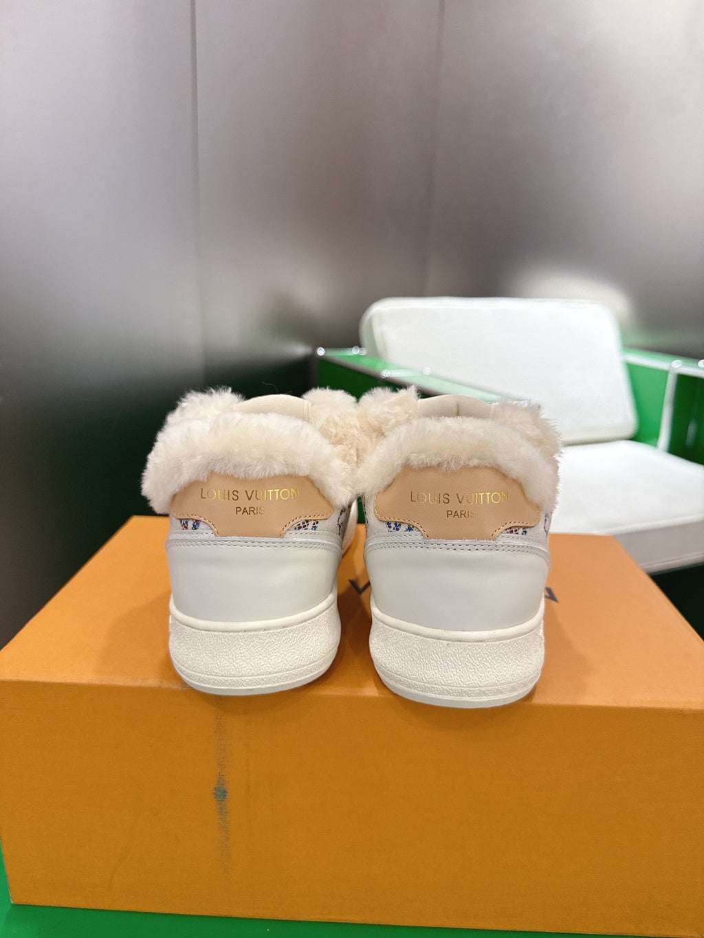 Pair of white Louis Vuitton high-top sneakers with shearling back tab detail