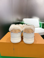Pair of white Louis Vuitton high-top sneakers with shearling back tab detail