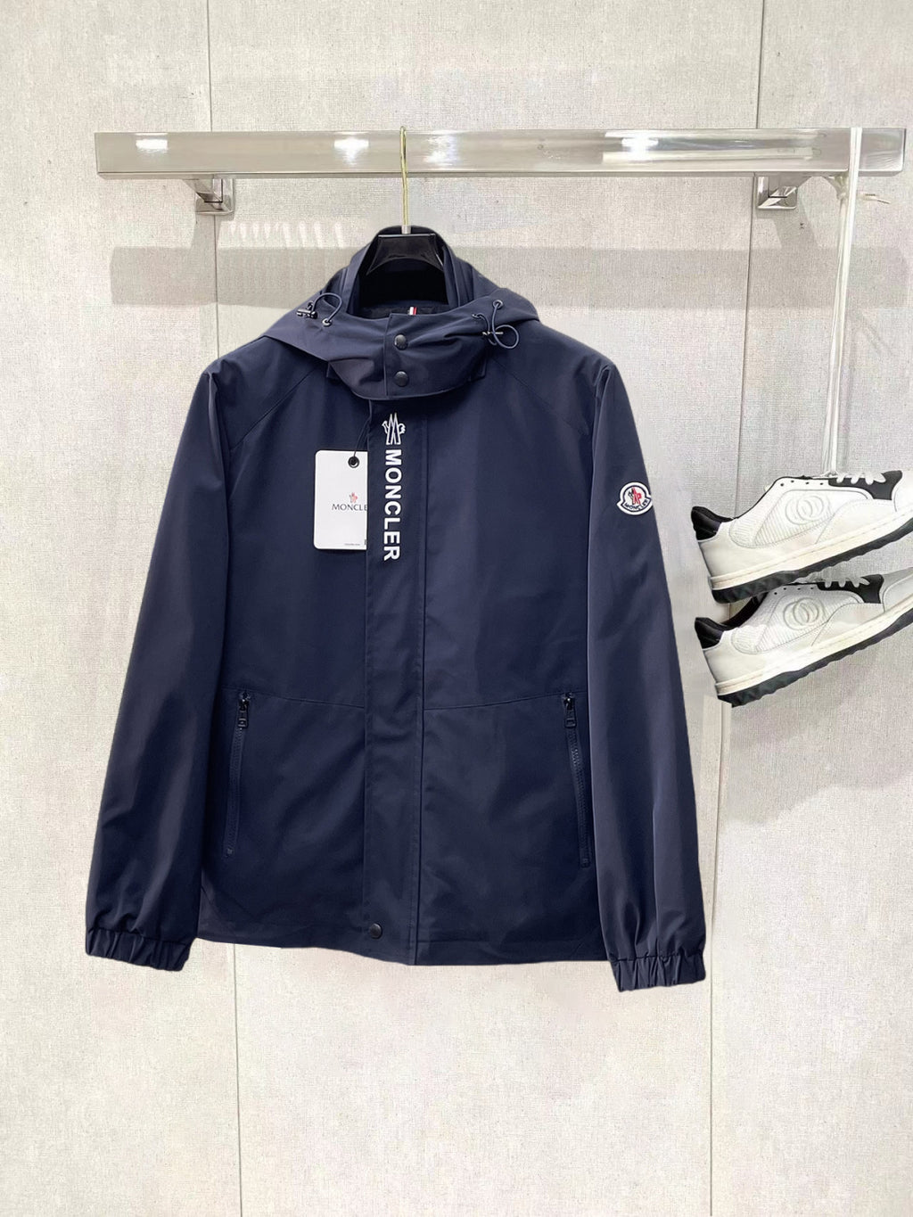 Navy Moncler long hooded jacket with front zipper and drawstring cuffs