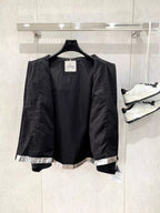 Moncler long jacket with black outer shell and visible interior lining
