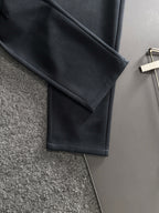 Dark pants leg with straight cut and neatly finished hem