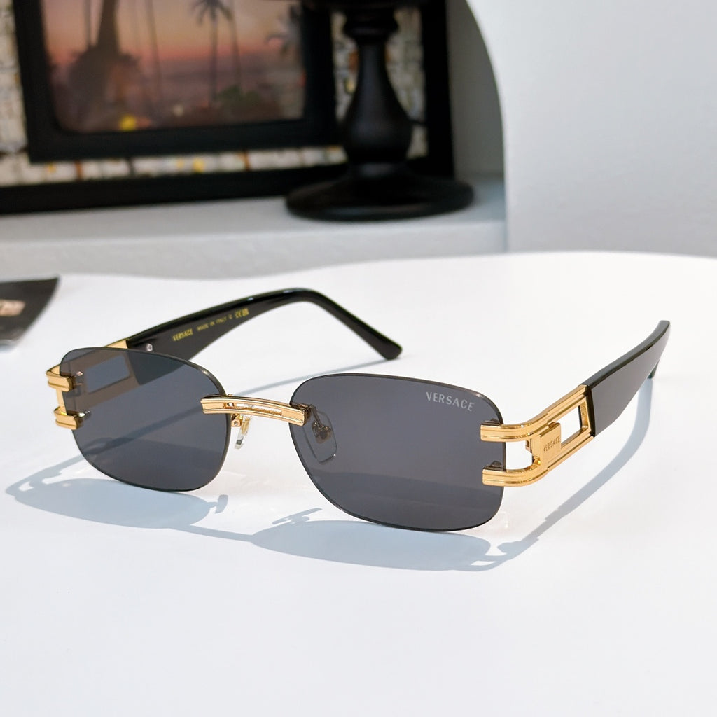 Sunglasses with dark gray lenses and black frame, gold bars on temples