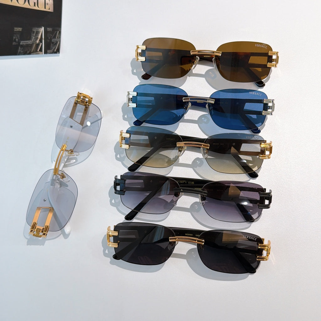 Stacked sunglasses assortment with blue, brown, and dark lenses, gold-tone frames