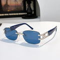Sunglasses with blue lenses and navy frame, gold accents, oversized cat-eye style