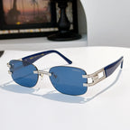 Sunglasses with blue lenses and navy frame, gold accents, oversized cat-eye style