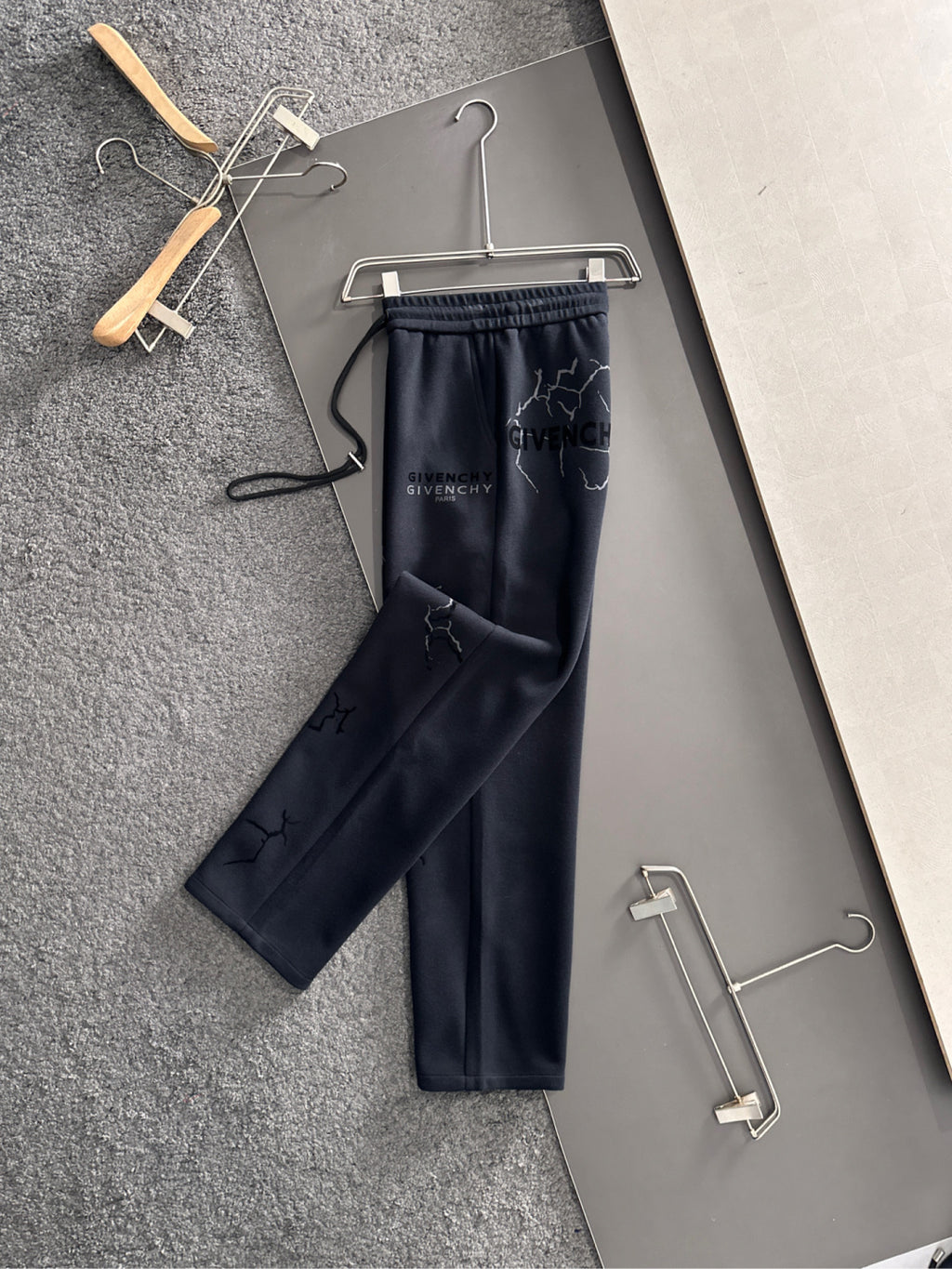 Navy drawstring sweatpants with elastic waistband and Givenchy Paris logo accents on legs
