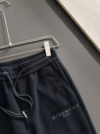 Close-up of black elastic-waist drawstring sweatpants with Givenchy Paris logo on chest