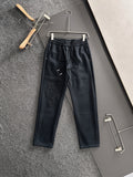 Dark pants with elastic waist, drawstring, side pockets, embroidered cross pattern