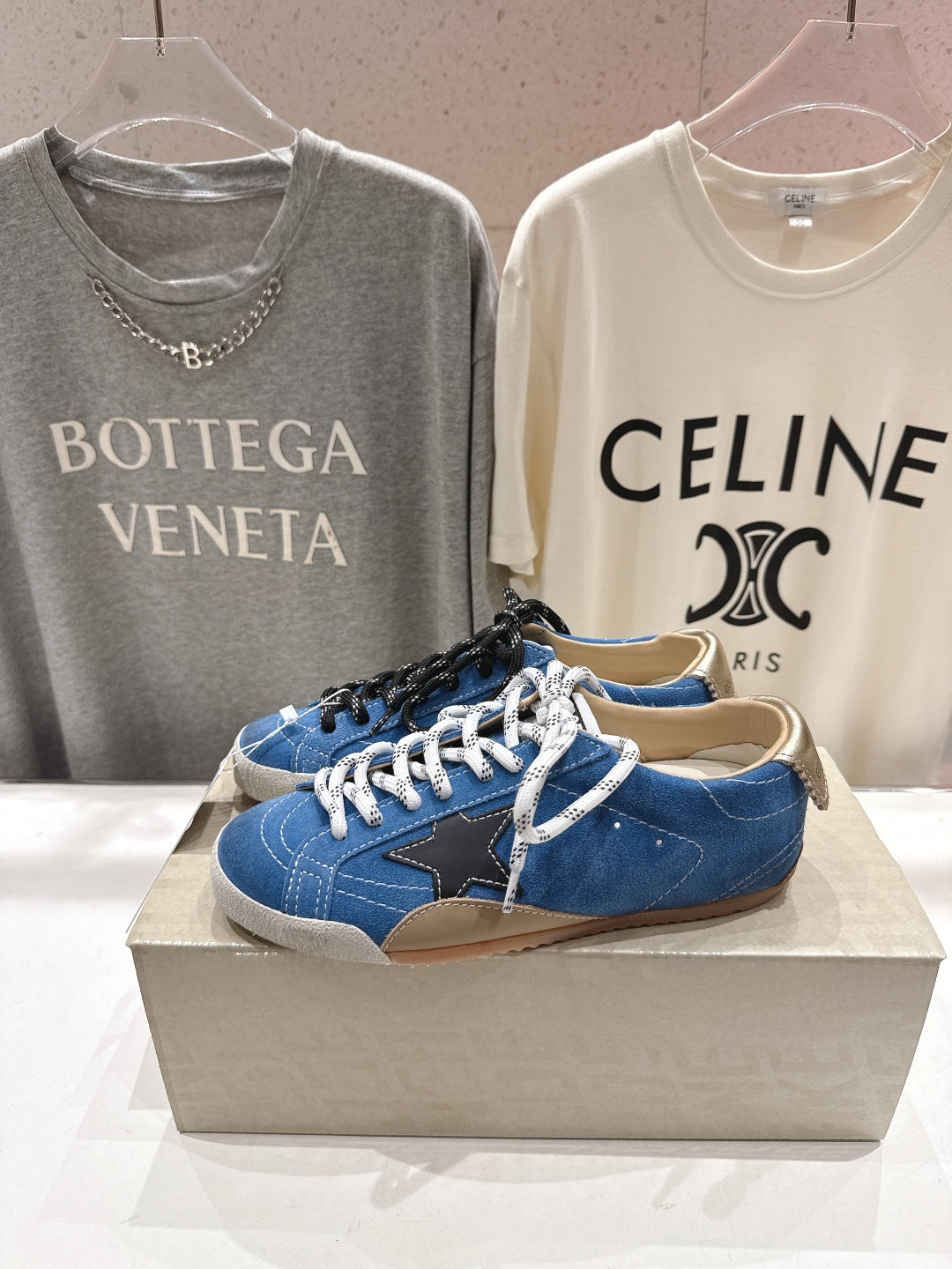 Blue low-top sneakers with white laces and black side star, gum sole