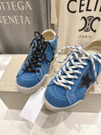 Pair of blue low-top sneakers with black and white laces, gum soles