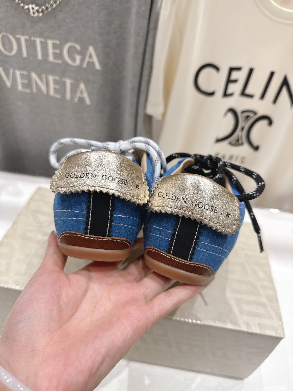 Blue low-top sneakers with 'Golden Goose' heel label and gum outsole
