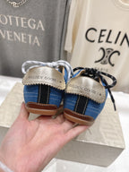 Blue low-top sneakers with 'Golden Goose' heel label and gum outsole