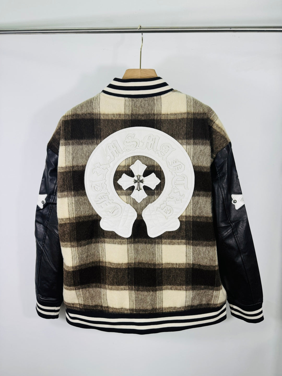Plaid varsity jacket back view with large crest patch and ribbed striped collar