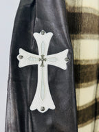 White cross appliqué on black leather-look sleeve of plaid varsity jacket