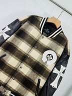 Plaid varsity jacket with crest patch and cross motifs on black sleeves