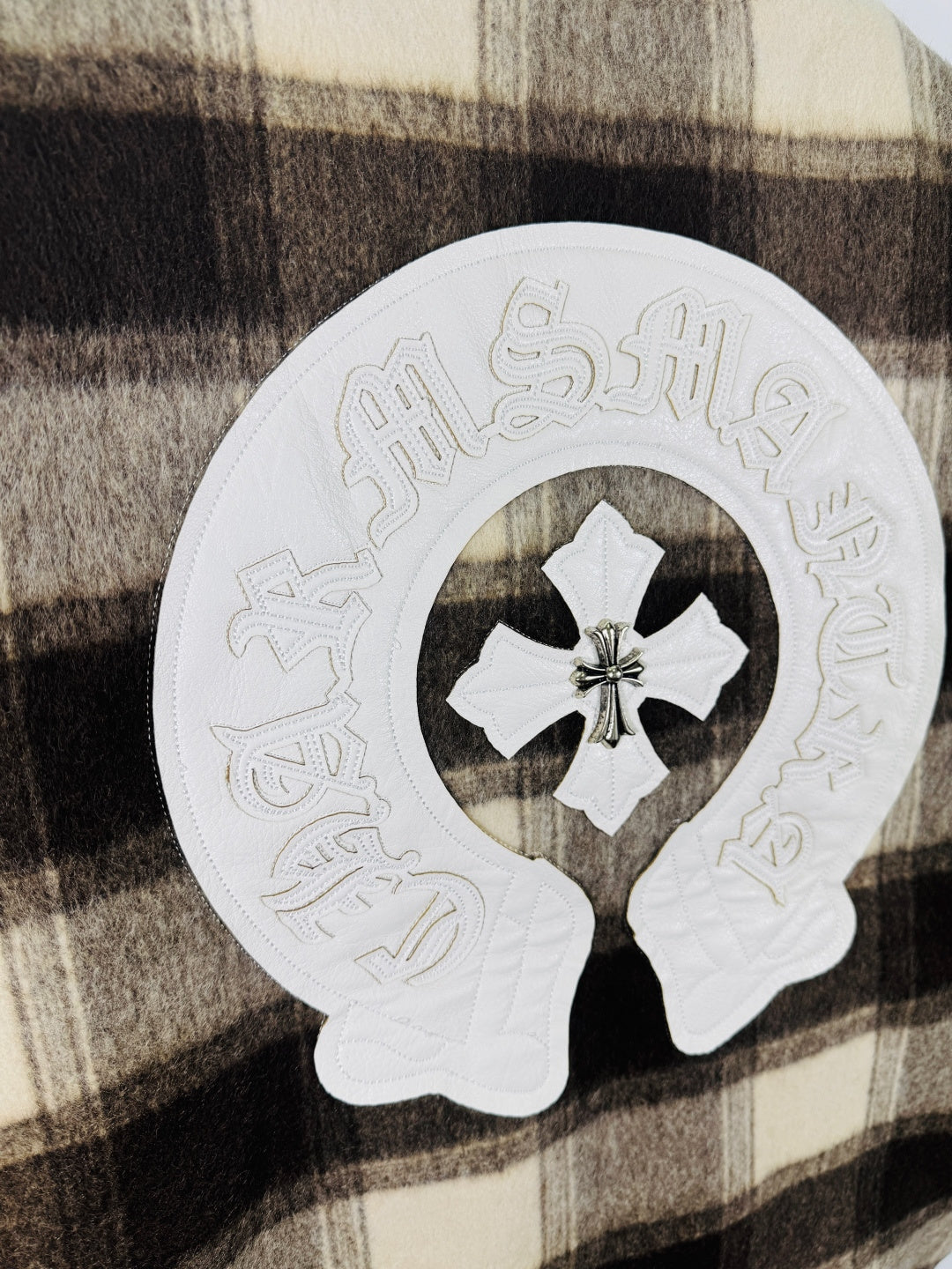 Long chrome clothes, white embroidered circular patch with floral star center