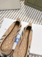 Burberry check ballet flats viewed from inside, tan cushioned footbed
