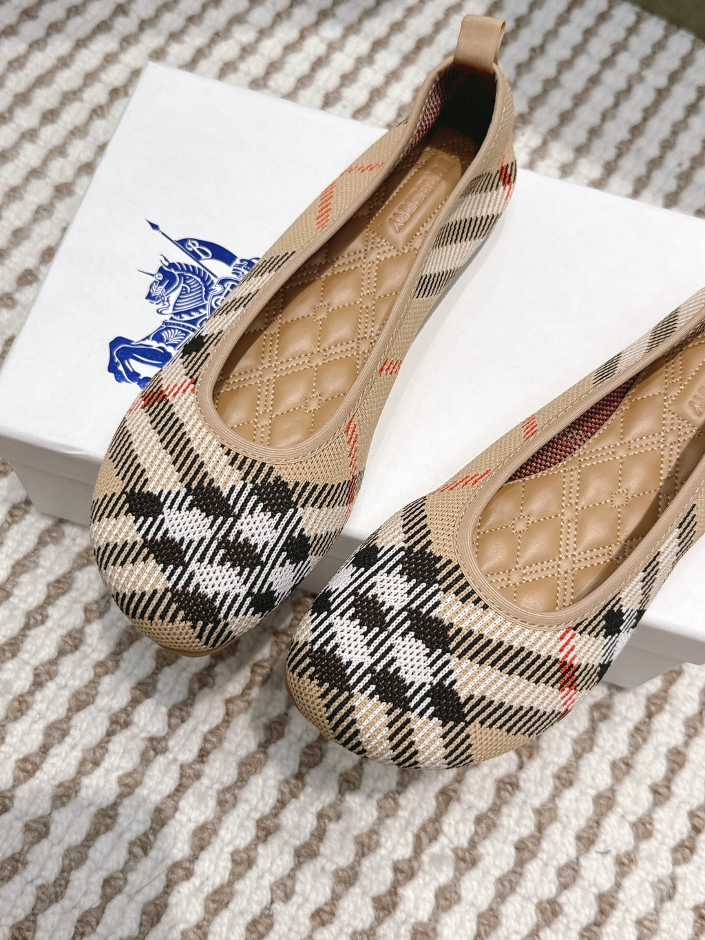 Burberry check ballet flats angled view, tan lining and stitched interior