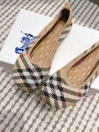 Burberry check ballet flats angled view, tan lining and stitched interior