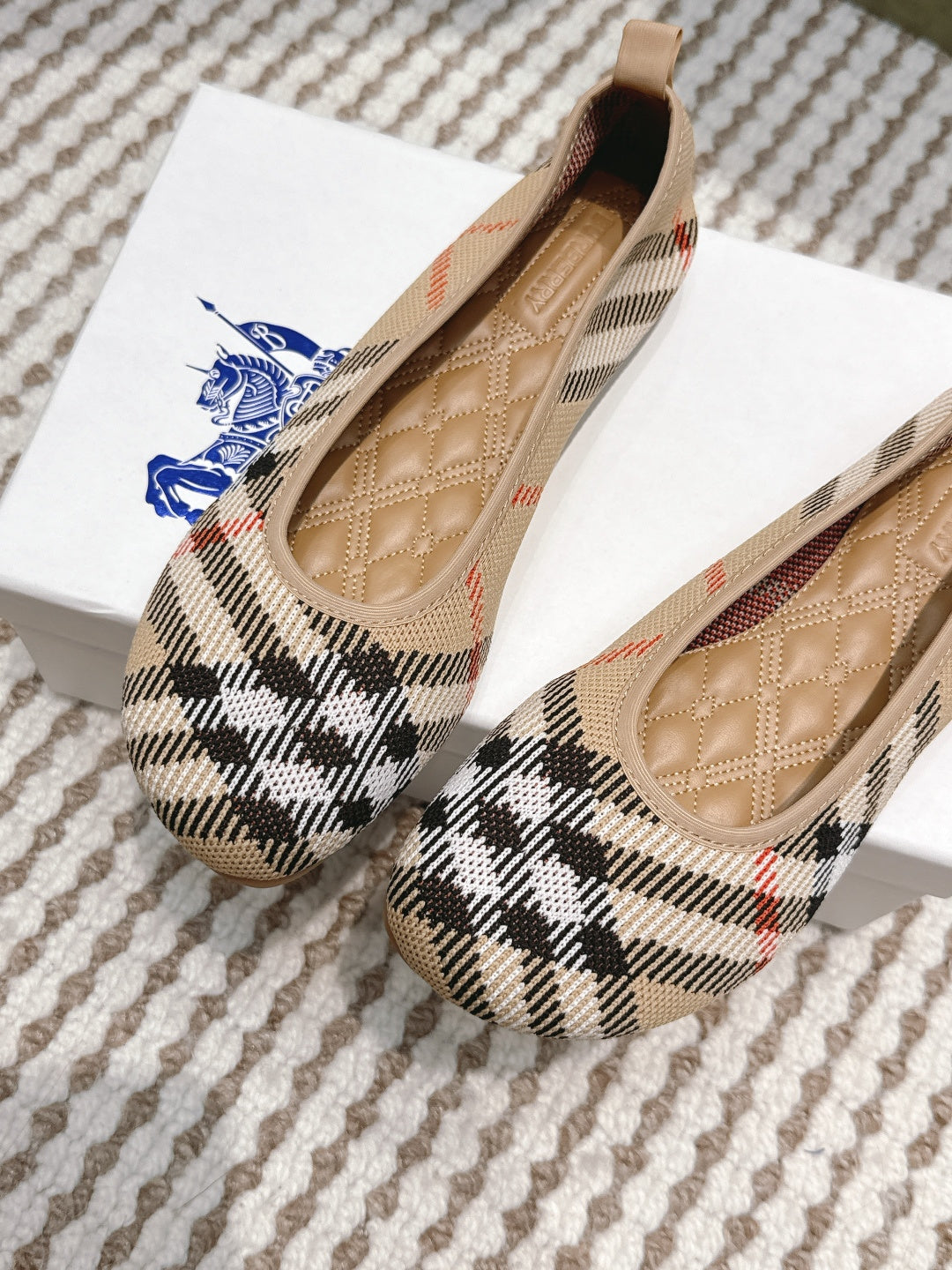 Burberry check ballet flats angled view, tan lining and stitched interior