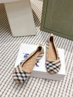 Burberry check ballet flats pair with tan leather lining and low rounded toe