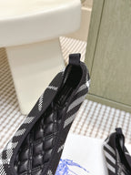 Burberry heel and side tab on slip-on shoes, black quilted leather and check