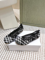 Burberry check-pattern slip-on shoes, black and white, with curved toe seam
