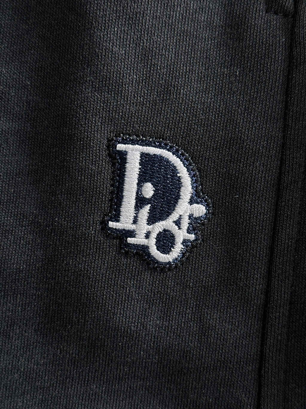 Dior pants logo patch on dark fabric near hip