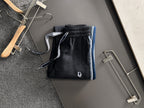 Dior pants with elastic waistband and drawstring; dark fabric with blue trim stripe