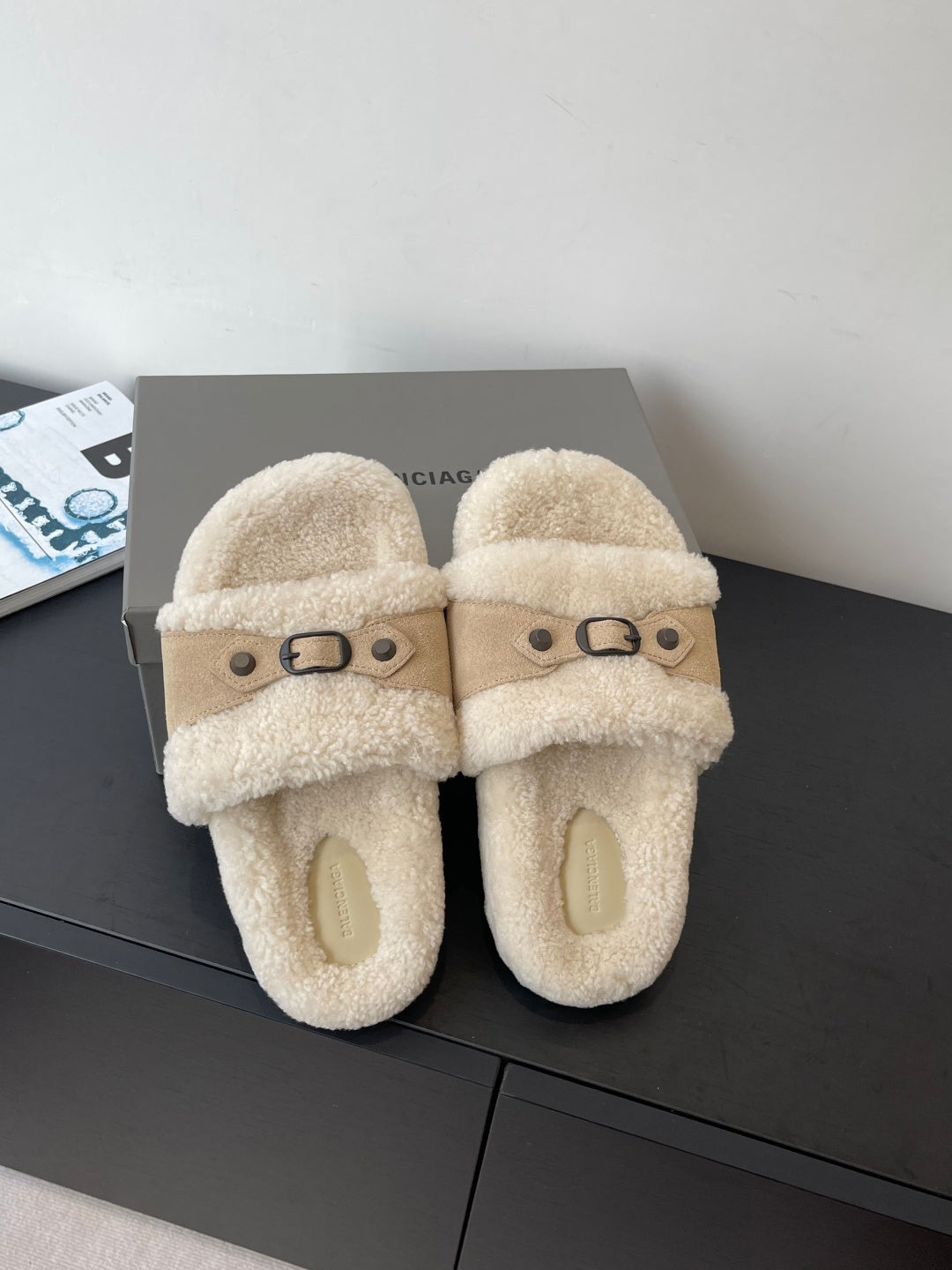 Shearling slide sandals with wide crossover straps and buckle accents, beige