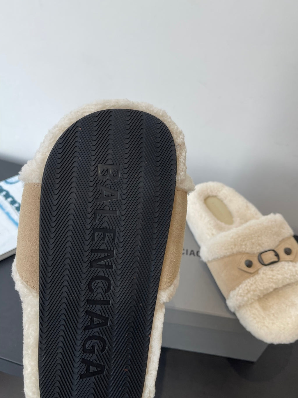 Beige shearling slide sandals with textured rubber outsole