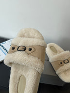 Beige shearling slide sandal with top strap and metal buckle, side view
