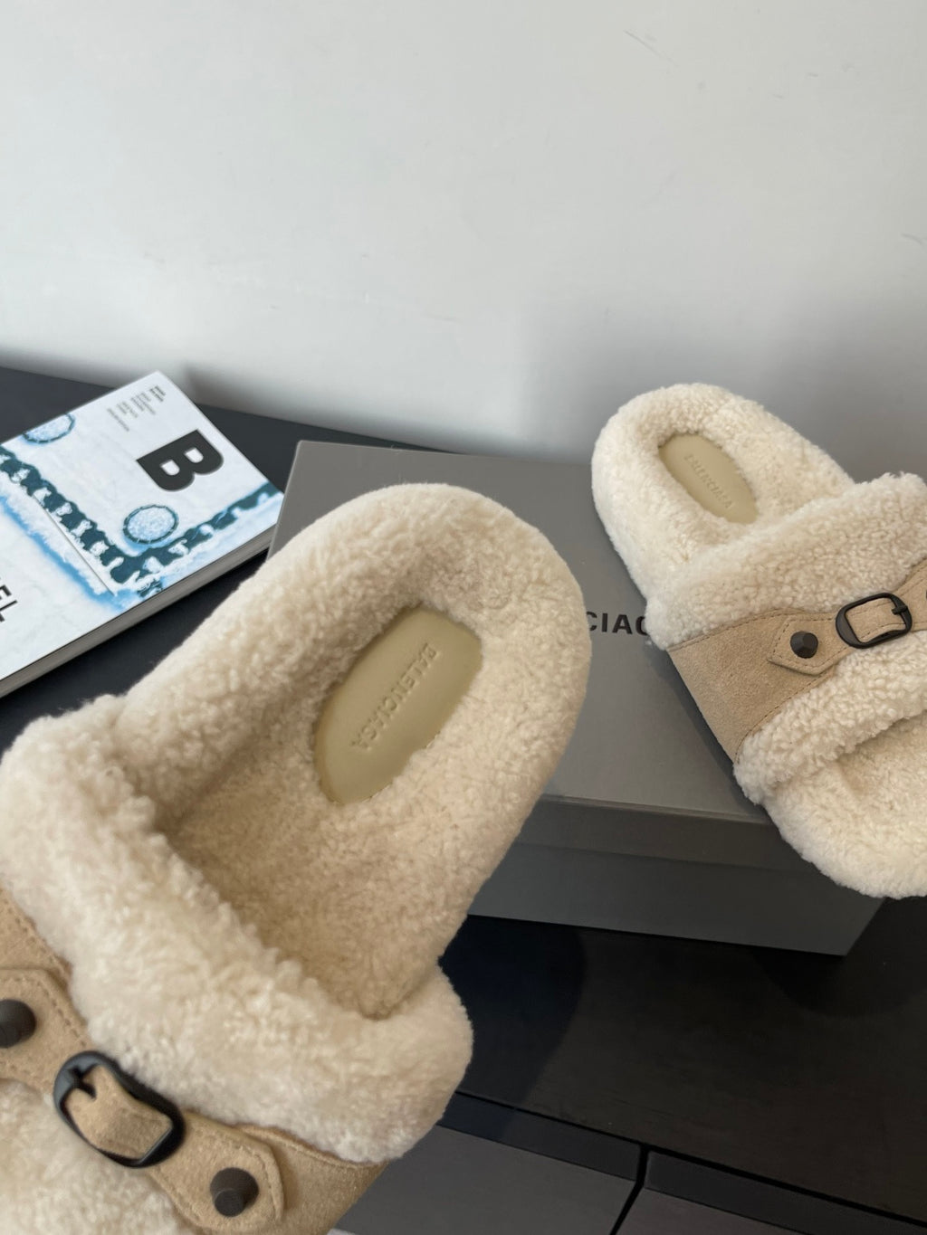 Beige faux shearling slide sandals, close-up of strap and metal buckle